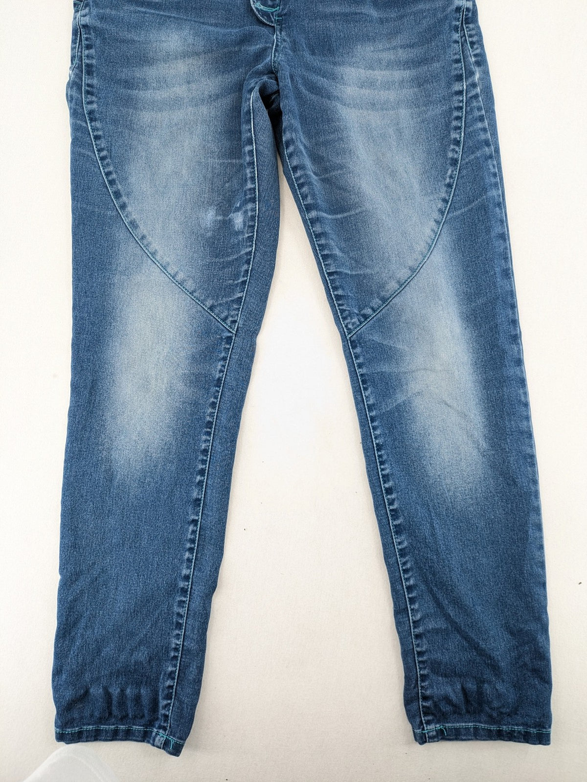 Rainbow blue straight jeans jogger style with button fly and contrasting turquoise stitching.
