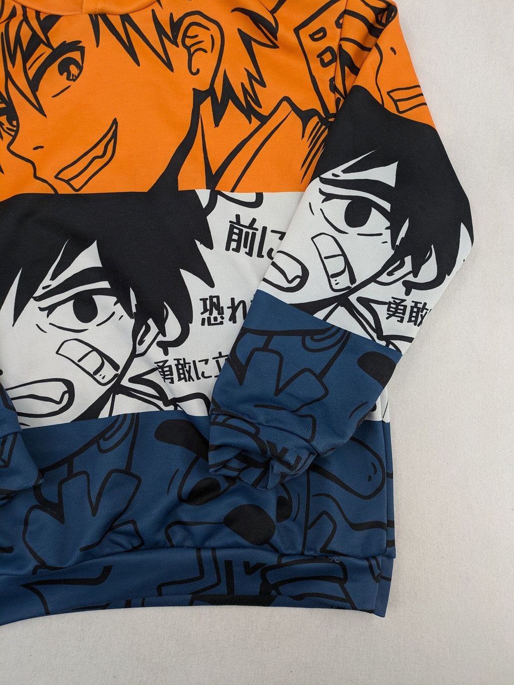 SHEIN orange zip-through hoodie with vibrant anime graphic print and colorblock design.