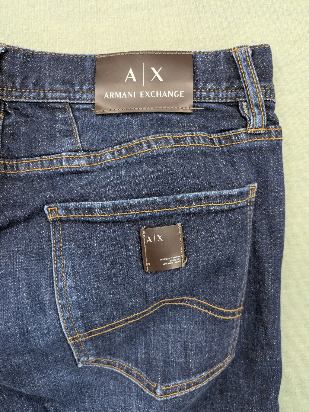 Armani Exchange blue slim fit jeans with distressed details and classic 5-pocket design.
