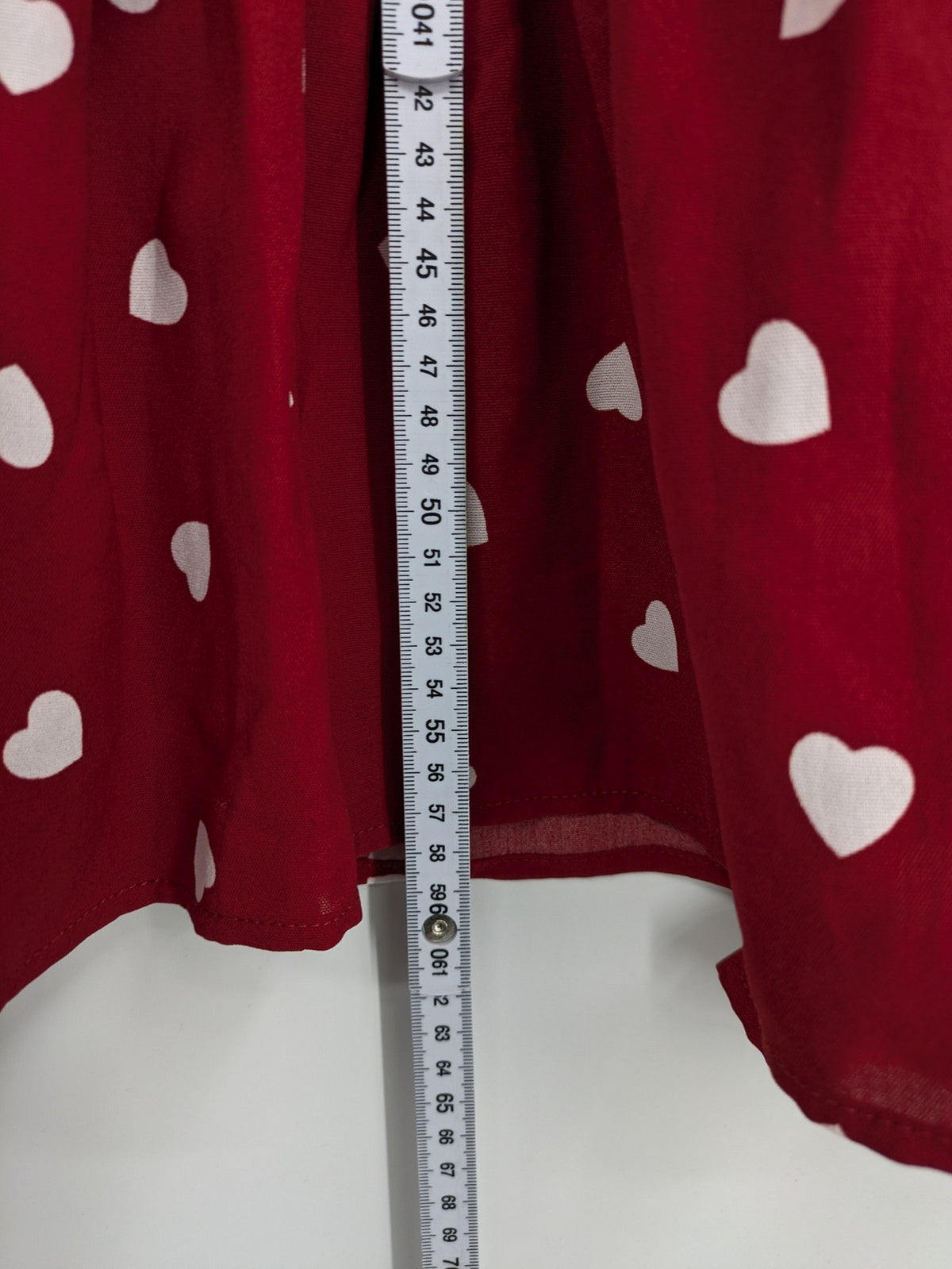 SHEIN burgundy top with white heart pattern and ruffled neckline detail.