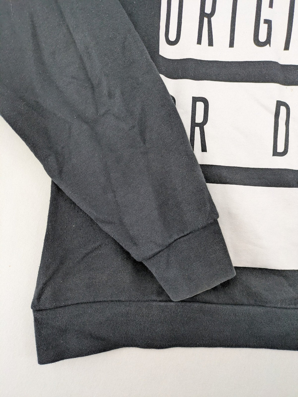 FSBN black hoodie with "BE ORIGINAL OR DIE" graphic print, slim fit, cotton-polyester blend.
