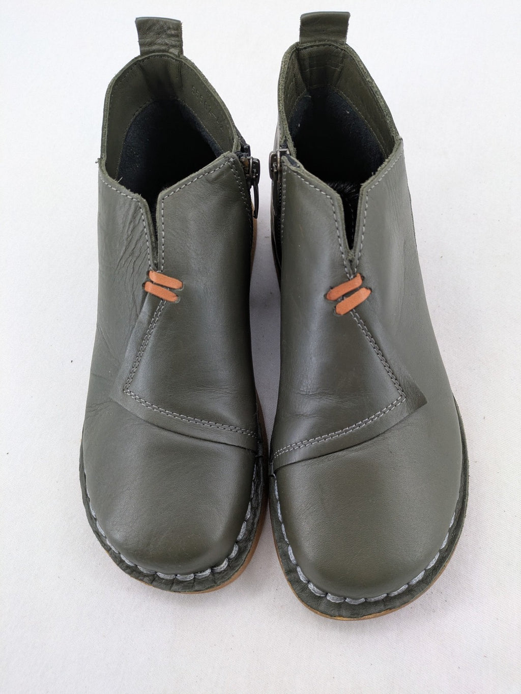 ALS green leather booties with side zipper and decorative stitching.