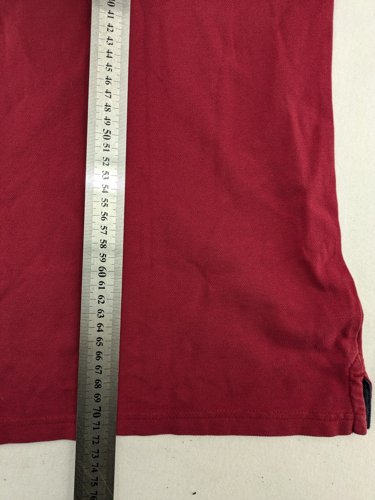 GANT burgundy polo shirt with embroidered shield logo and contrasting navy collar details.