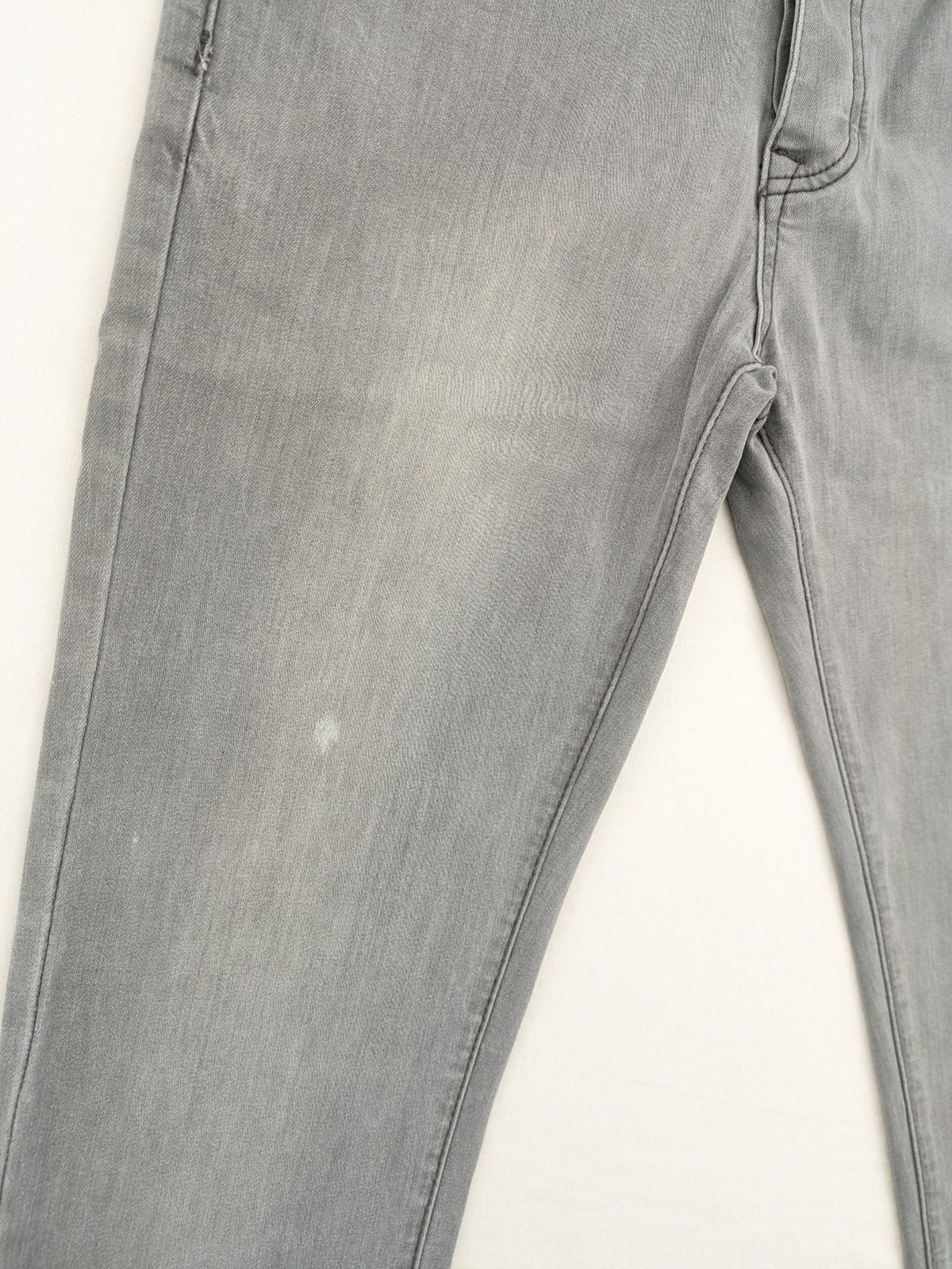 Born Rich grey slim fit jeans with logo patch and washed denim texture.