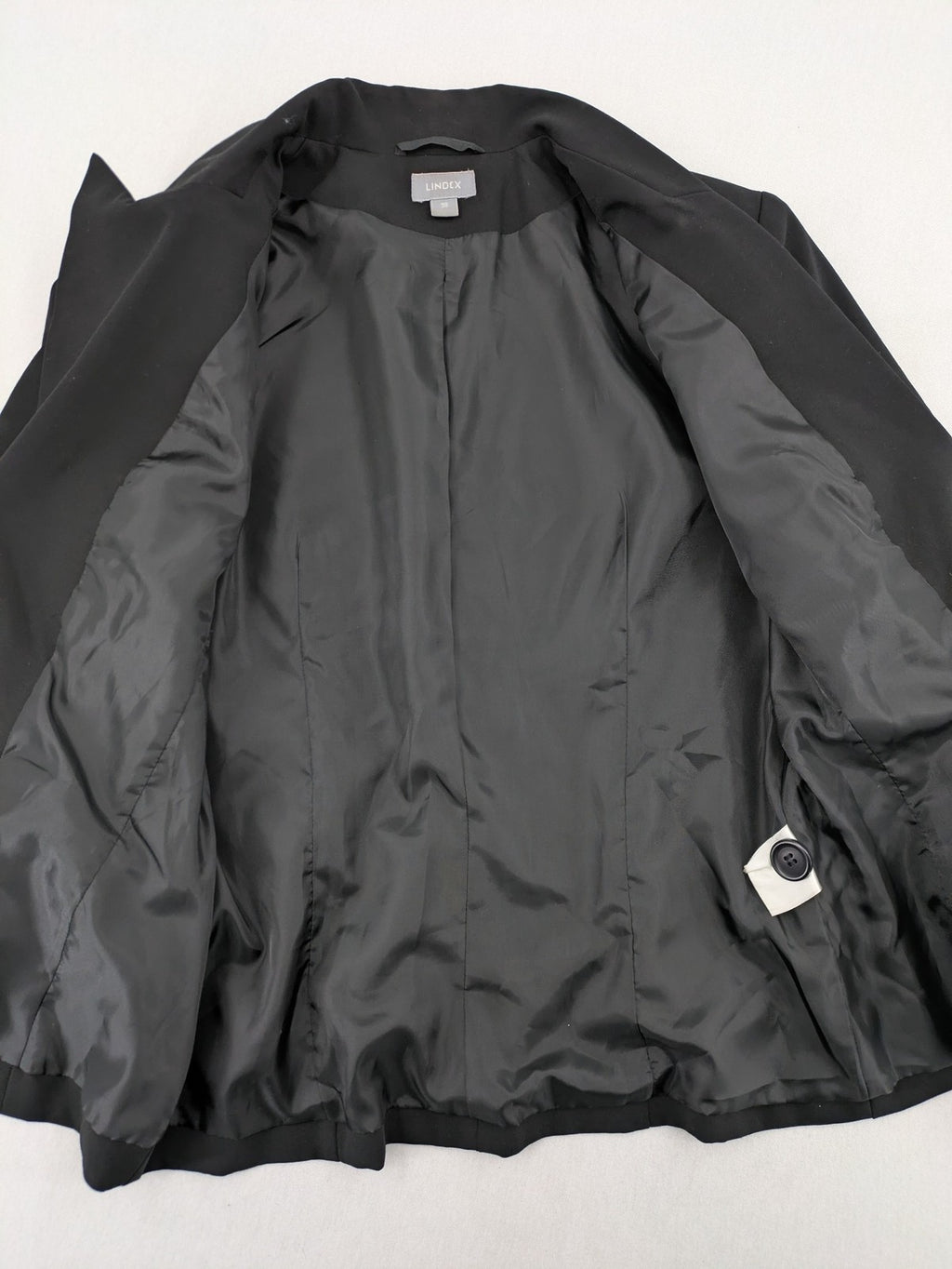 Lindex black blazer coat two-button design with subtle embroidery and tailored silhouette.
