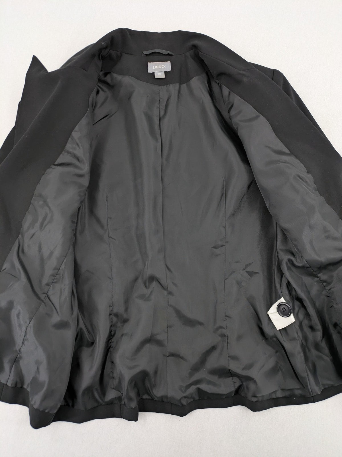 Lindex black blazer coat two-button design with subtle embroidery and tailored silhouette.