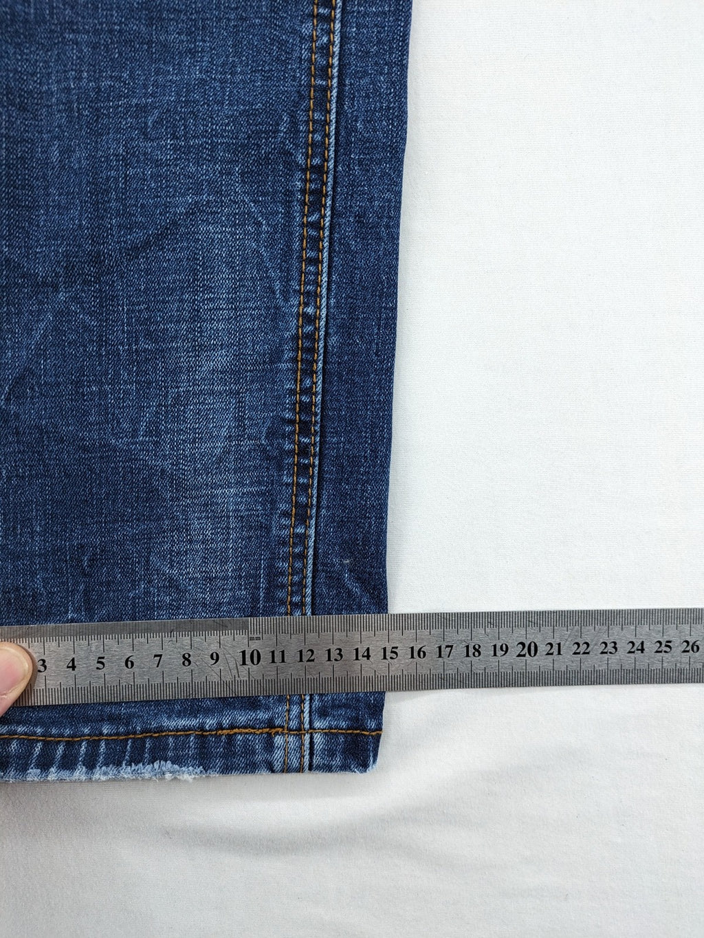 Soda blue straight jeans with distressed rips and button fly, cotton blend material.