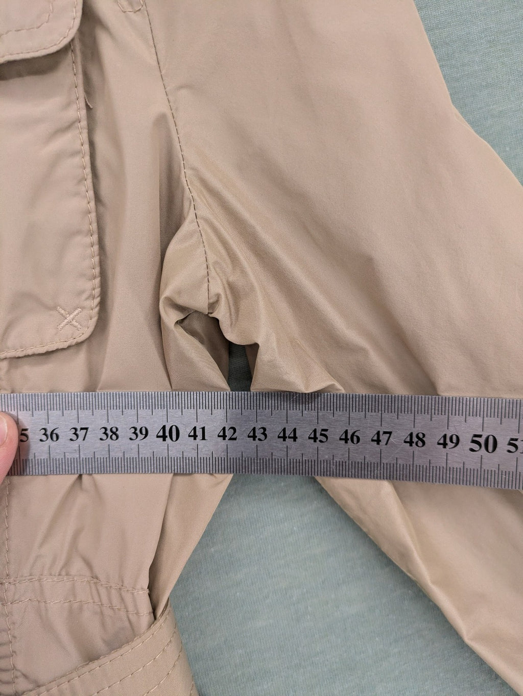 MORE & MORE beige field jacket with belt, four pockets, and standing collar.