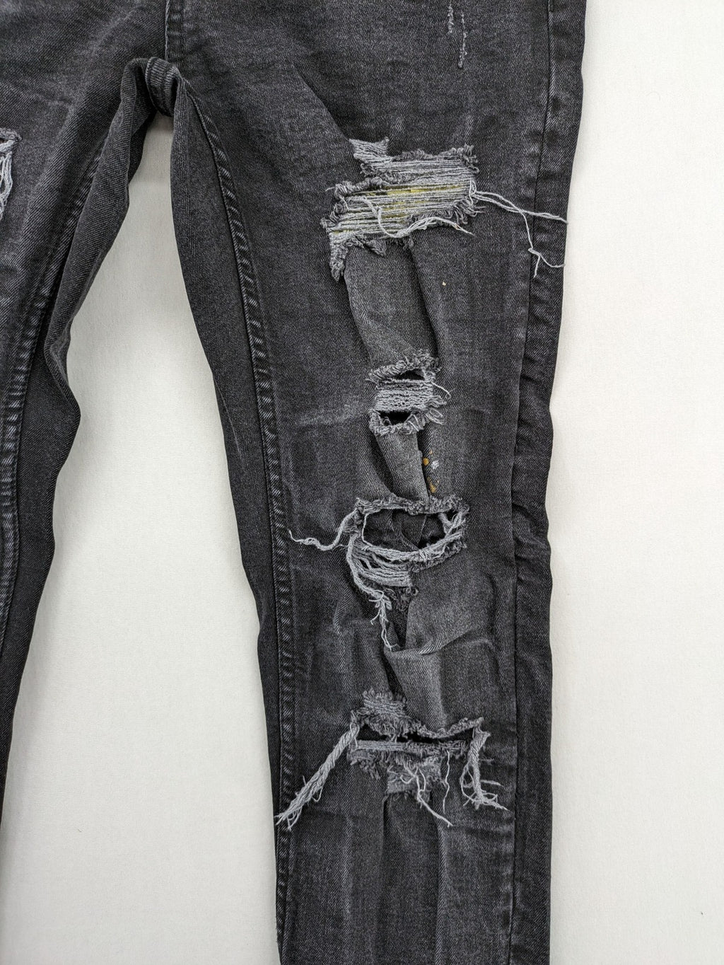 Black Squad skinny fit jeans black distressed ripped design with subtle paint splatter.