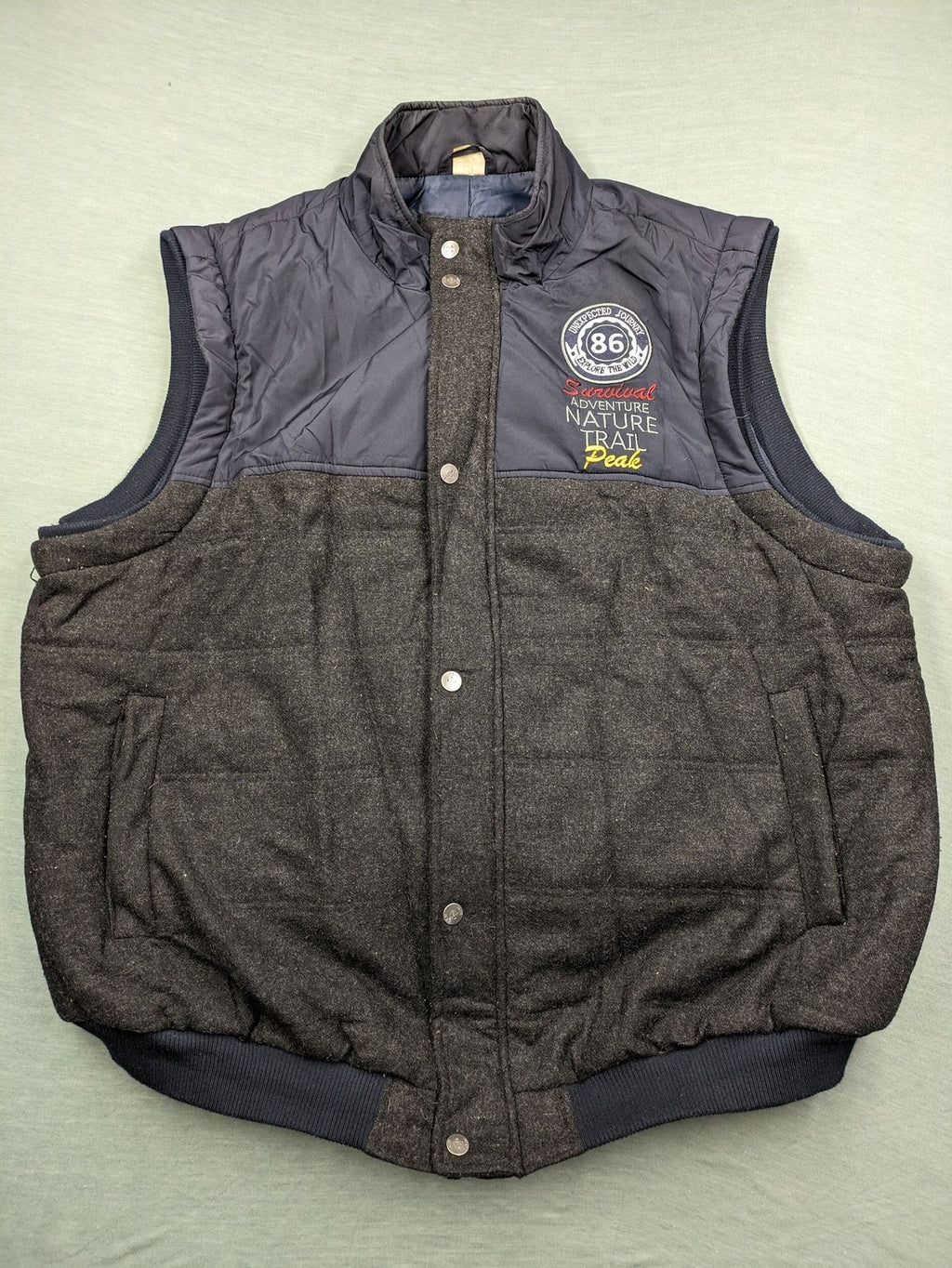 Men Plus grey and navy quilted vest with full zip and snap button placket.