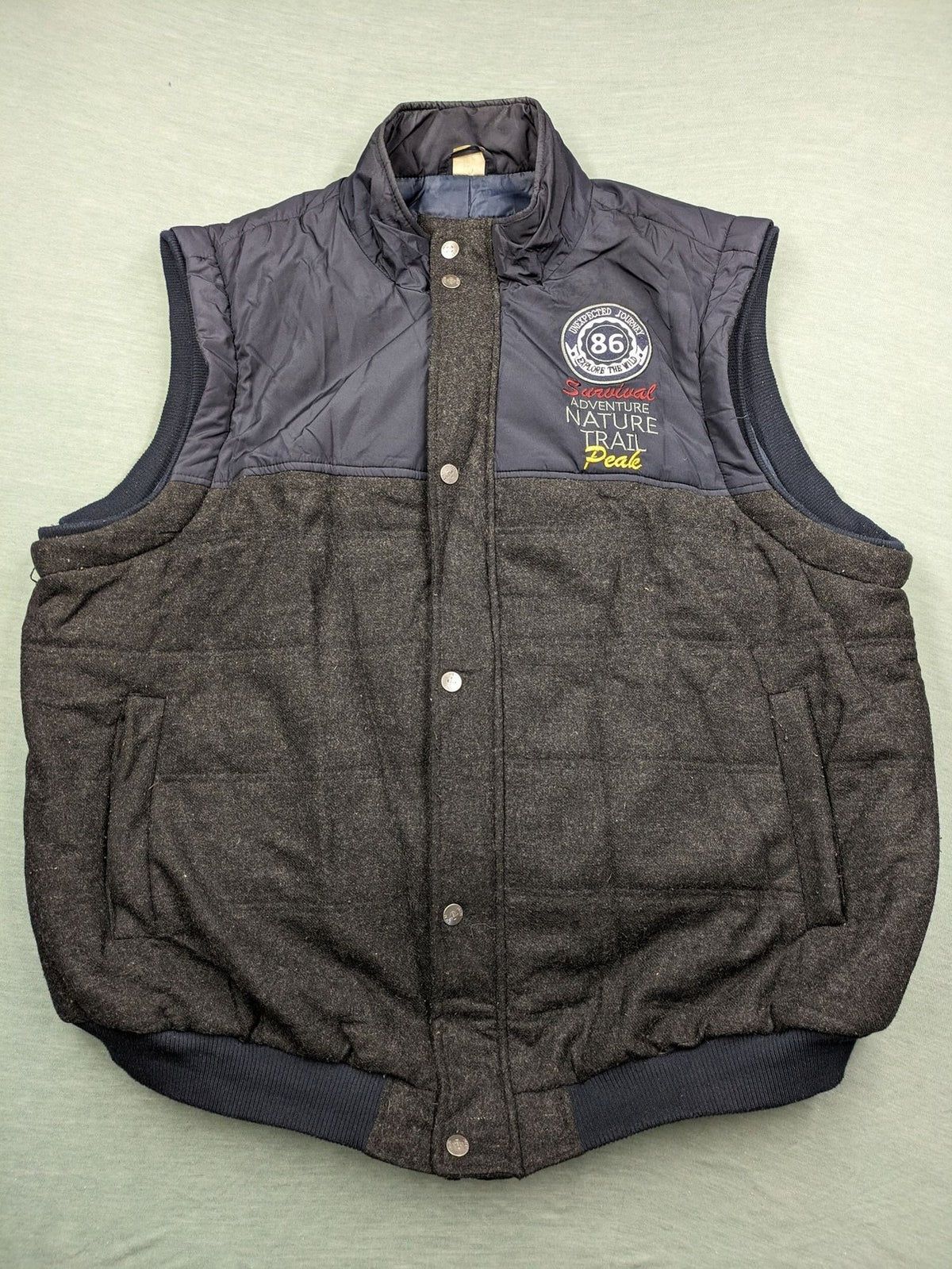 Men Plus grey and navy quilted vest with full zip and snap button placket.