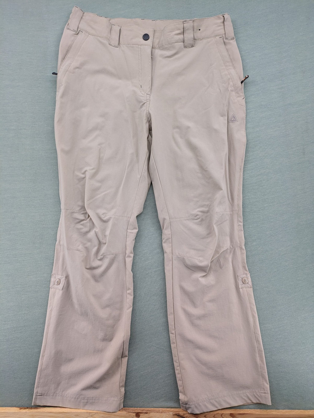 Hickory beige outdoor pants with multiple zippered pockets and stretch fabric for comfort.