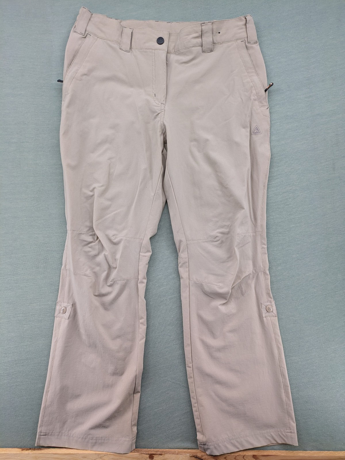 Hickory beige outdoor pants with multiple zippered pockets and stretch fabric for comfort.