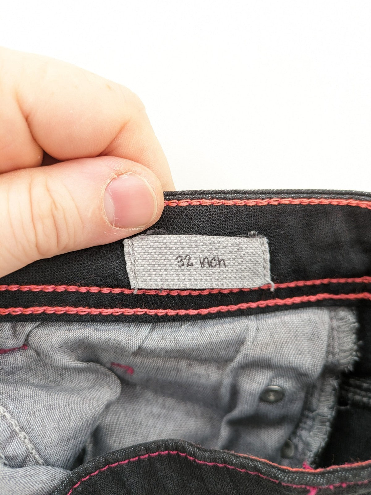 Denim black straight jeans with pink contrast stitching and classic 5-pocket style.
