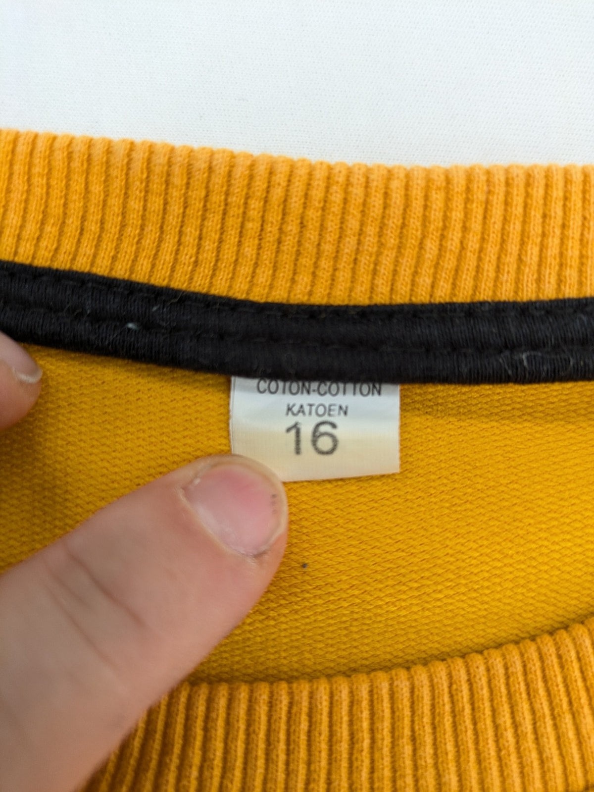 Columbia yellow turtle neck jumper with iconic logo, ribbed cuffs, and soft cotton material.