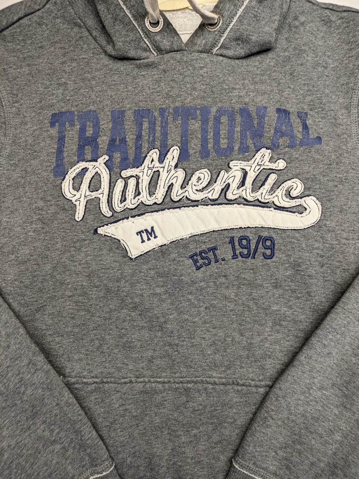Livergy grey zip-through hoodie with "Traditional Authentic" graphic, kangaroo pocket, soft material.