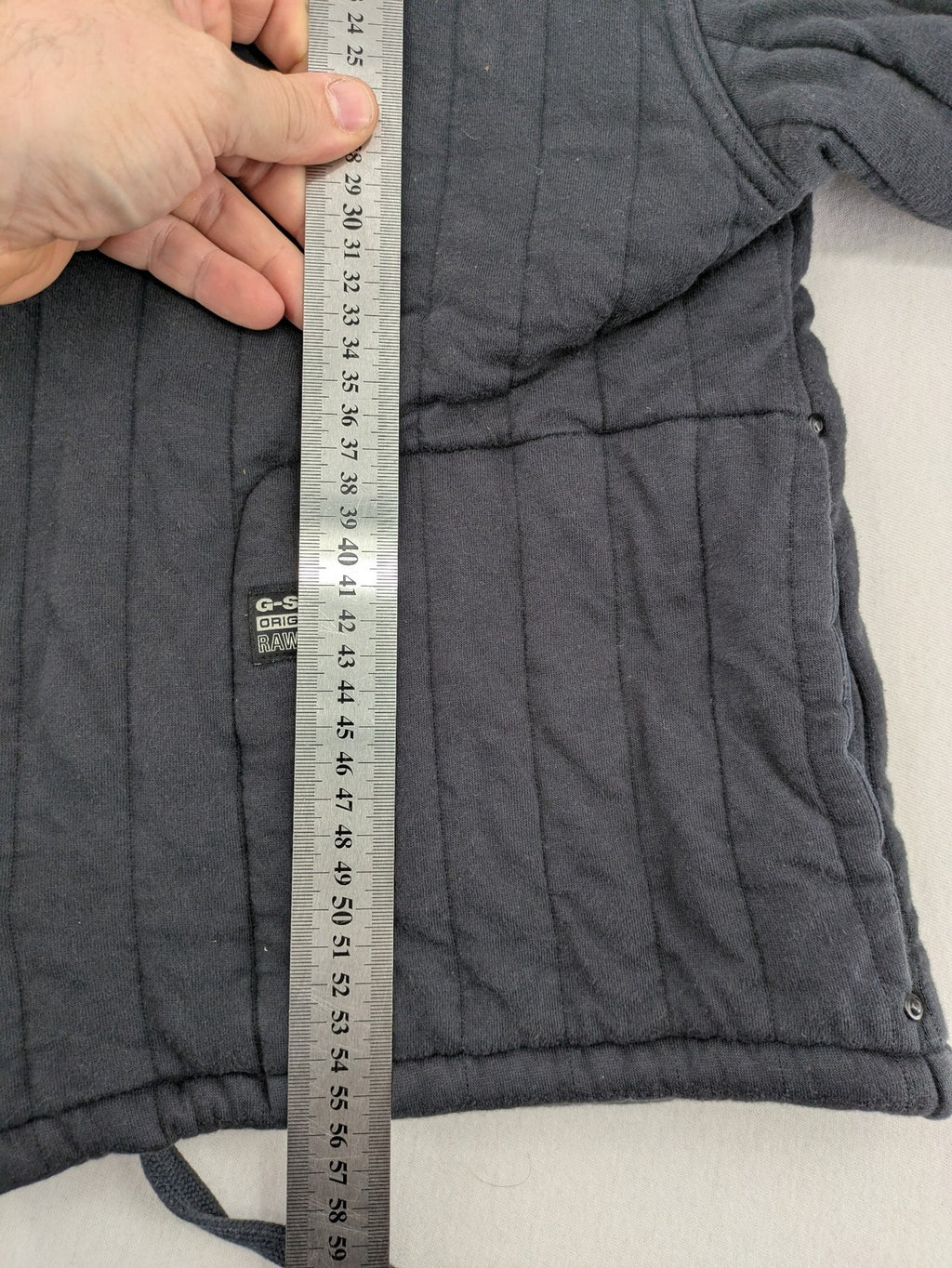 G-Star Raw grey quilted jacket with button closure and adjustable drawstring hem.