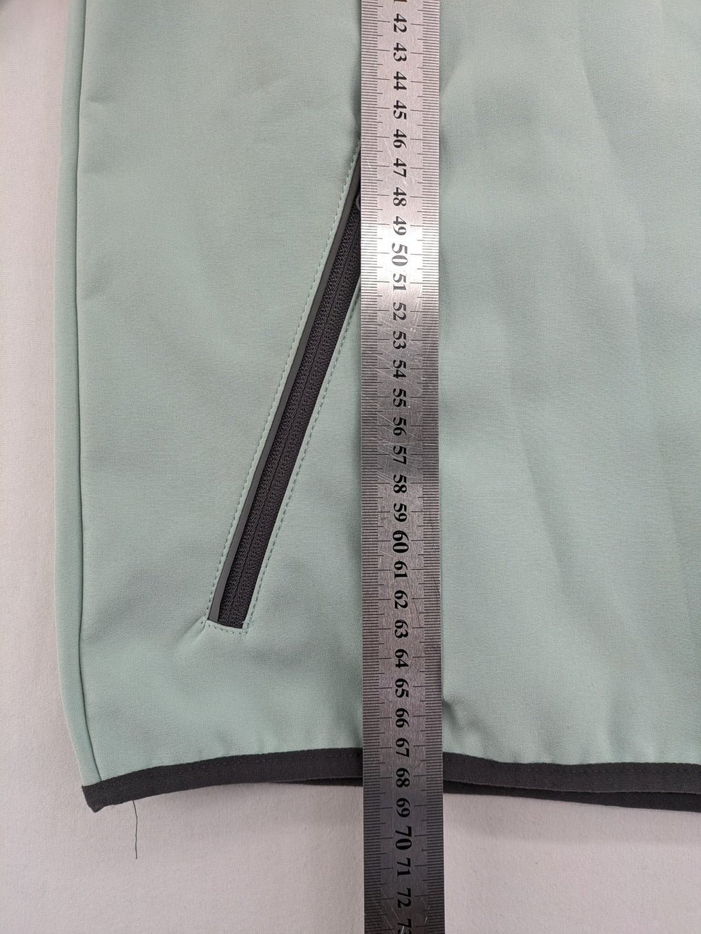 YFK outdoor jacket mint green softshell with dark grey fleece lining and hood.
