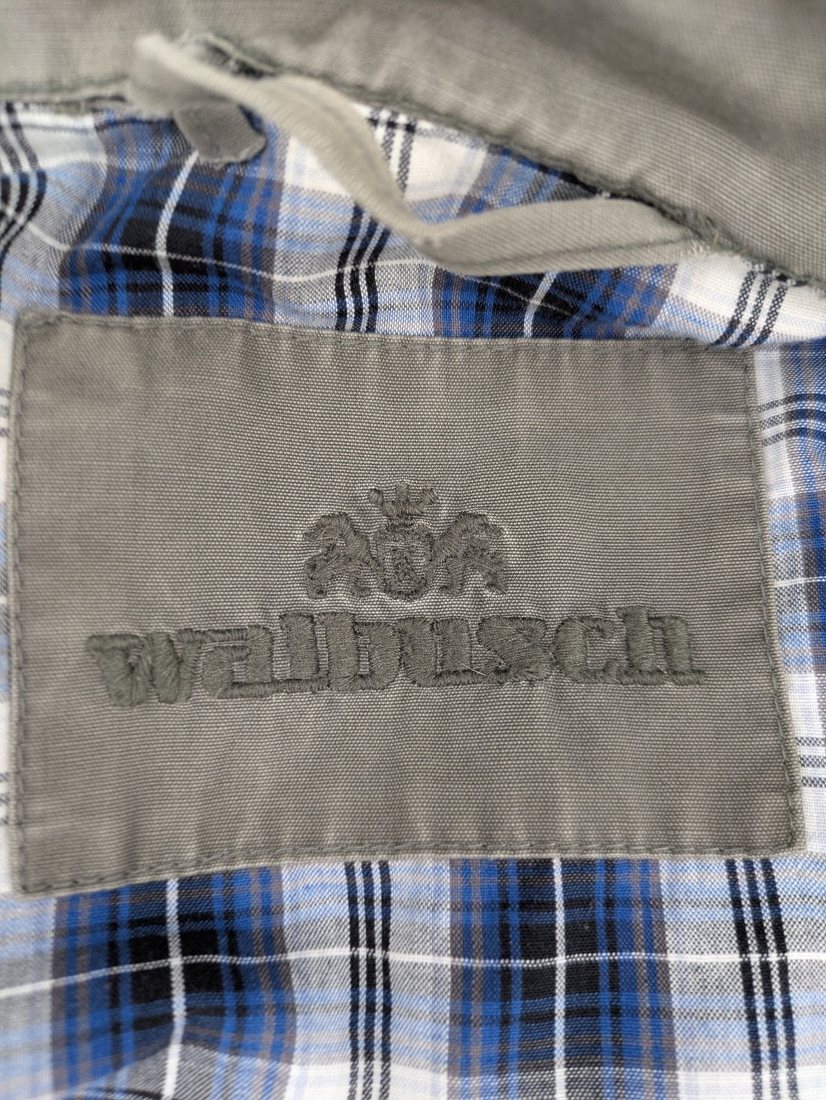 Walbusch khaki military jacket with checkered blue-white lining and multiple pockets.