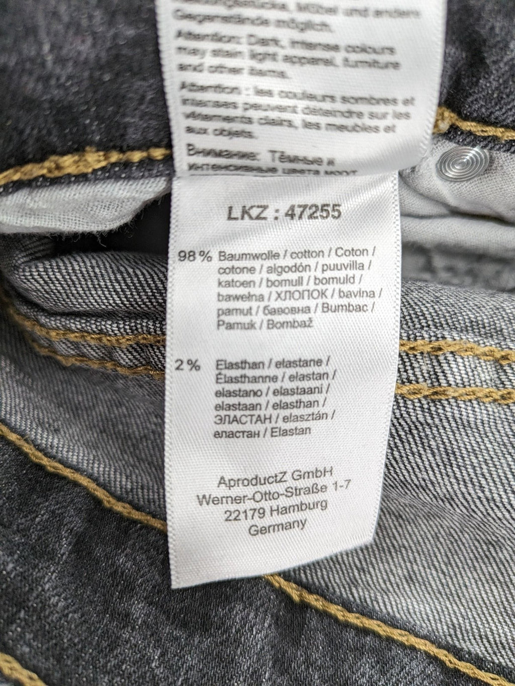 Bootcut grey low rise bootcut jeans five-pocket design with zipper and button closure.