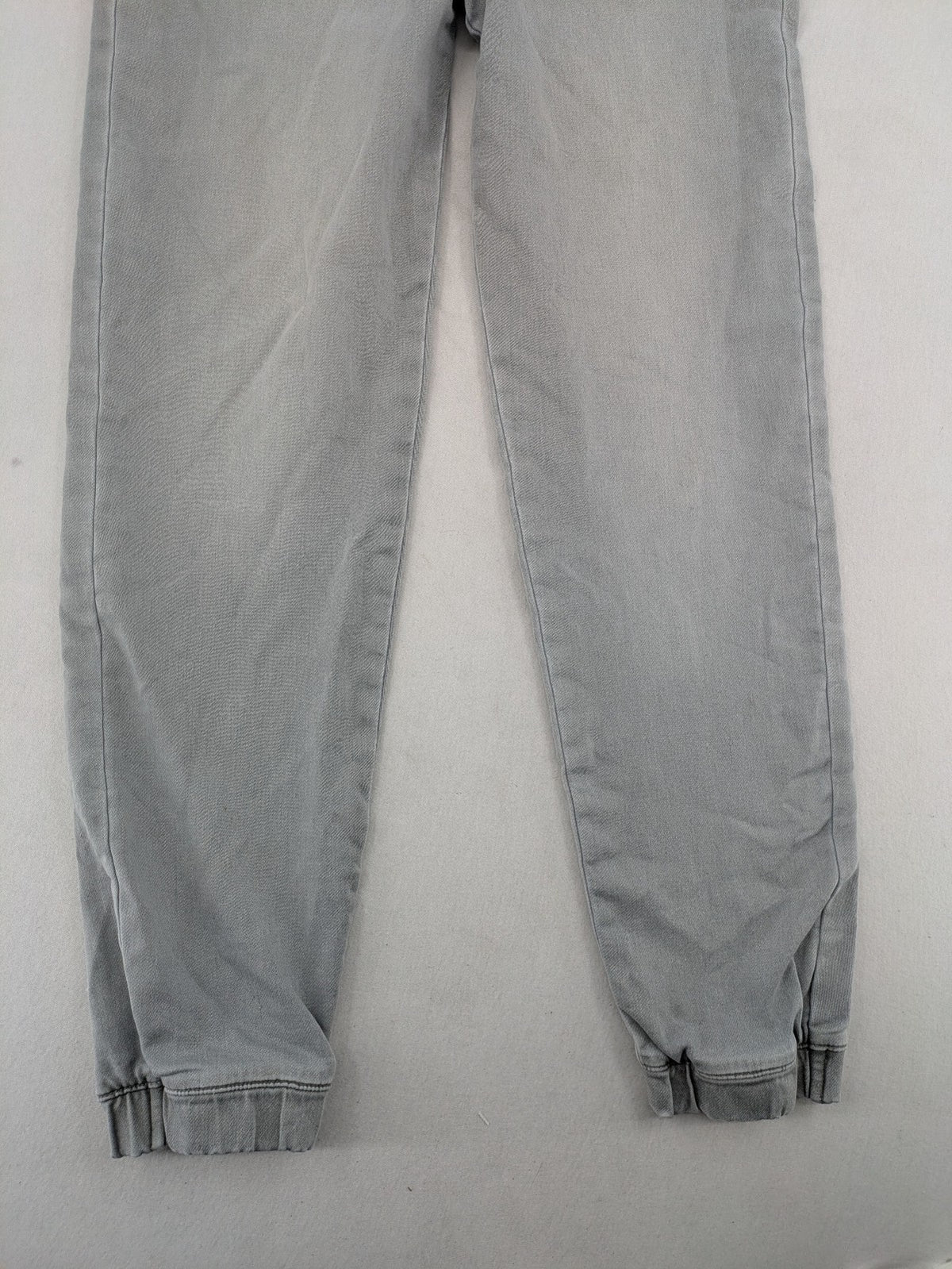 Denim & Co. grey jogger jeans with elastic waistband and ankle cuffs, cotton material.