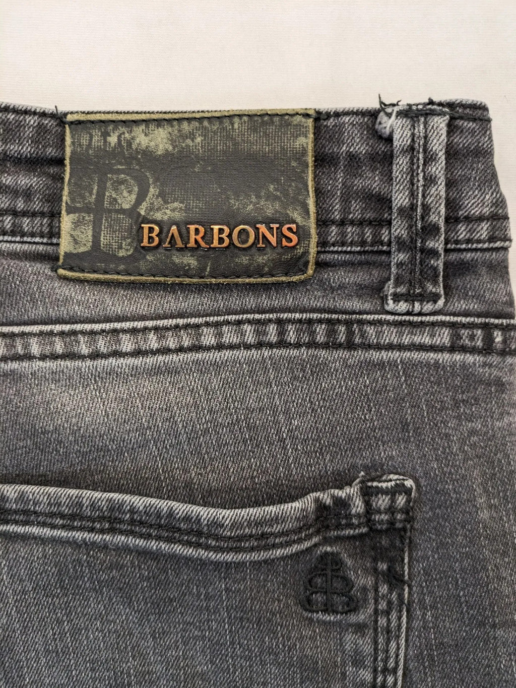 Denim grey straight jeans 5-pocket design with subtle brand details and zipper closure.