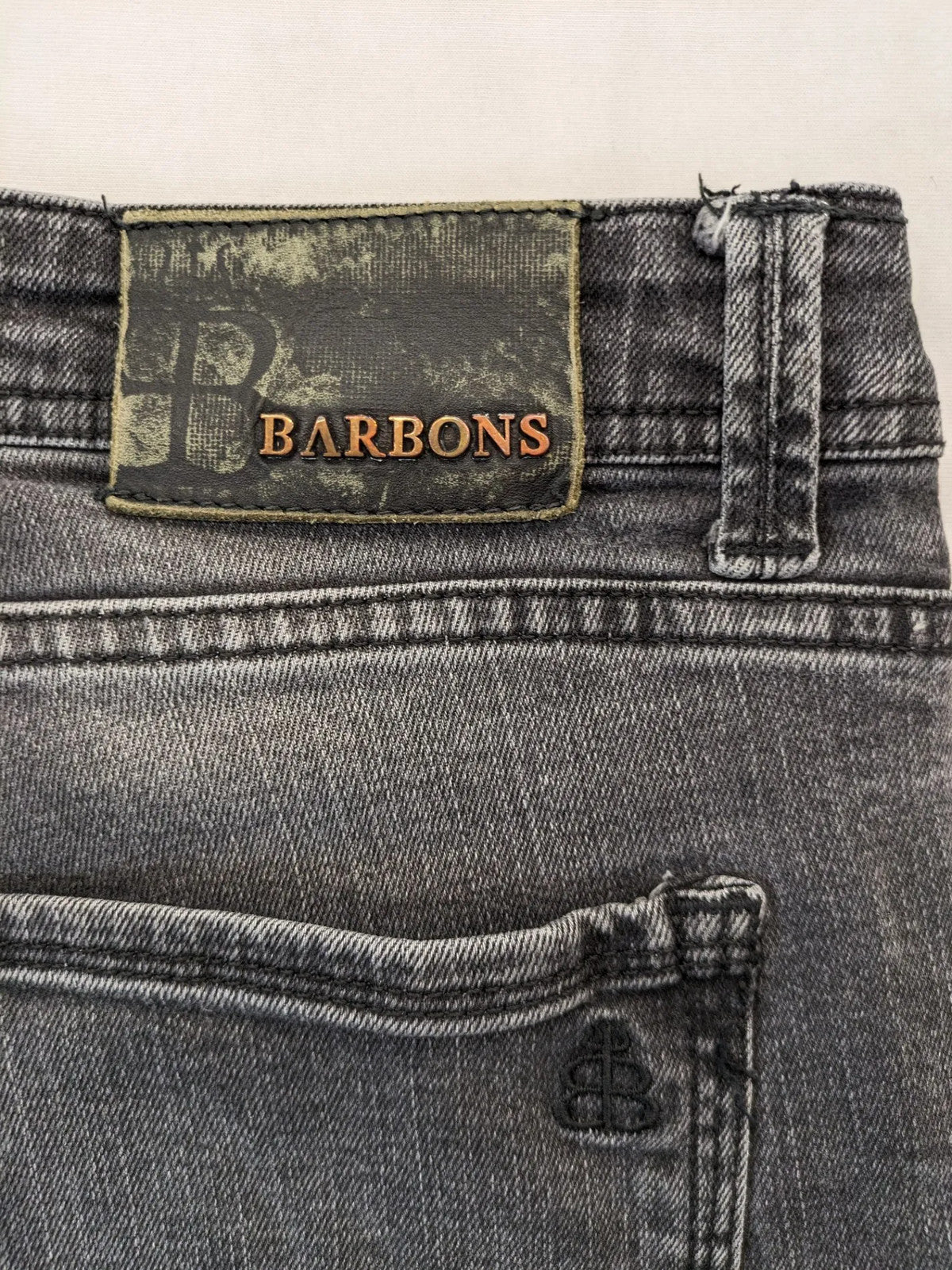 Denim grey straight jeans 5-pocket design with subtle brand details and zipper closure.