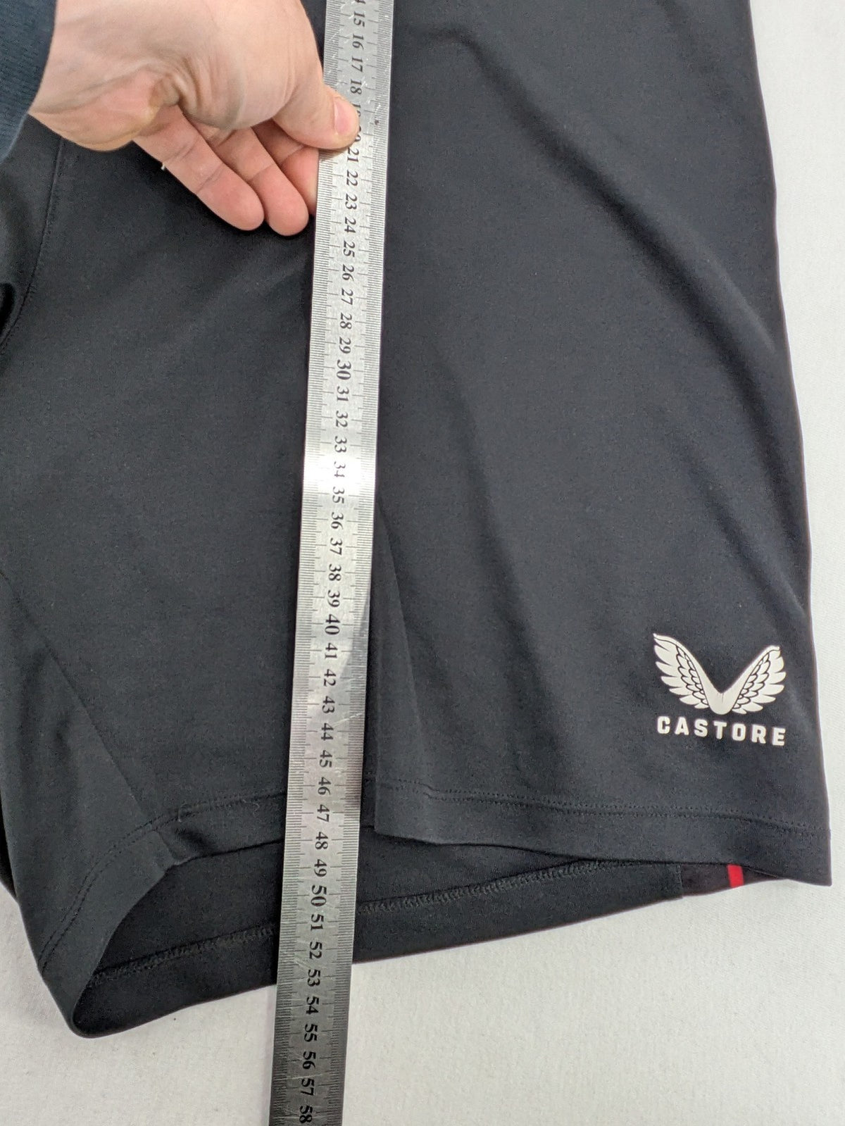 Bayer black training shorts with red side stripes, embroidered team crest and Castore logo.