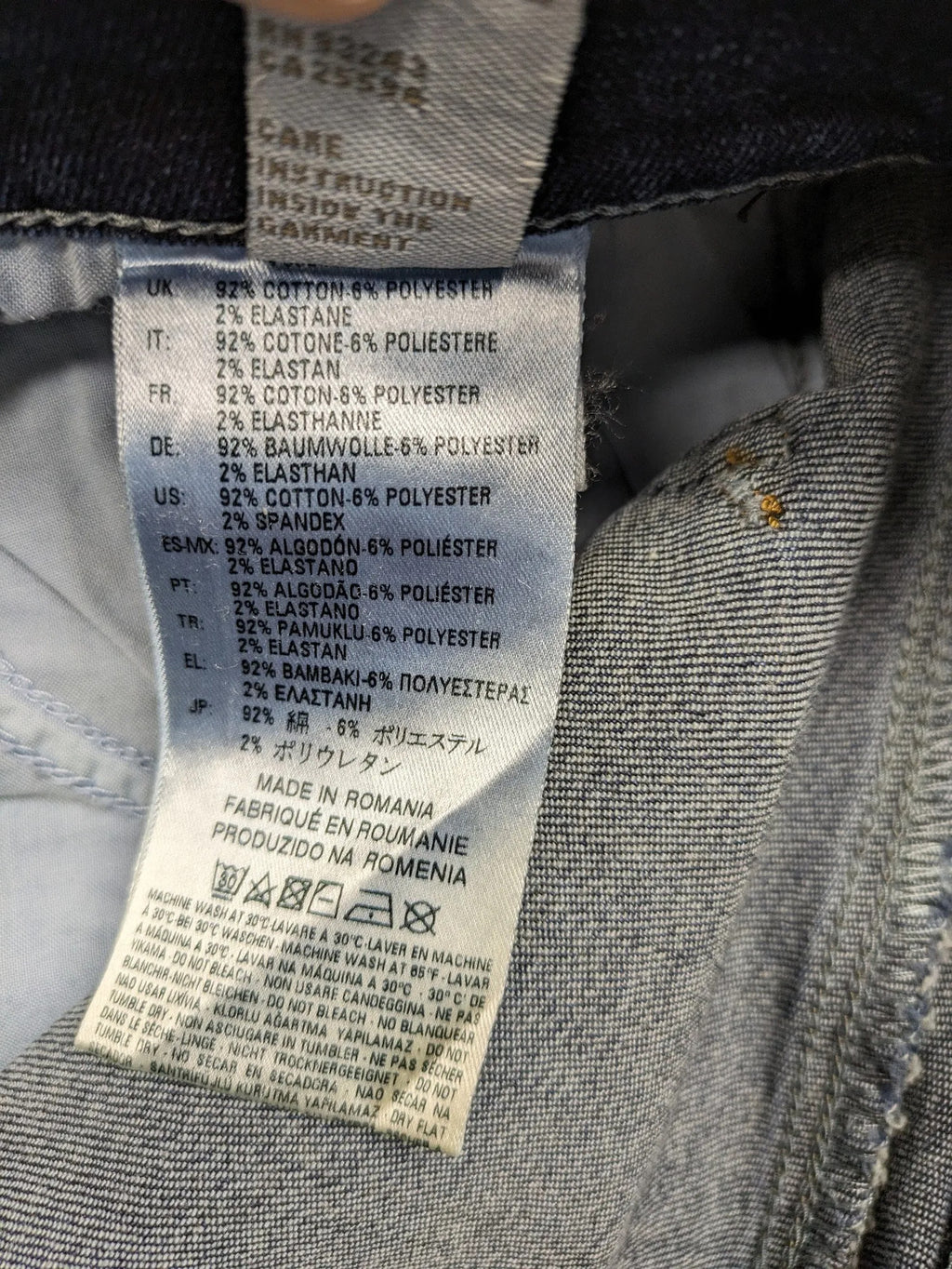 Diesel blue straight jeans with regular waist, dark wash, and stretch material.