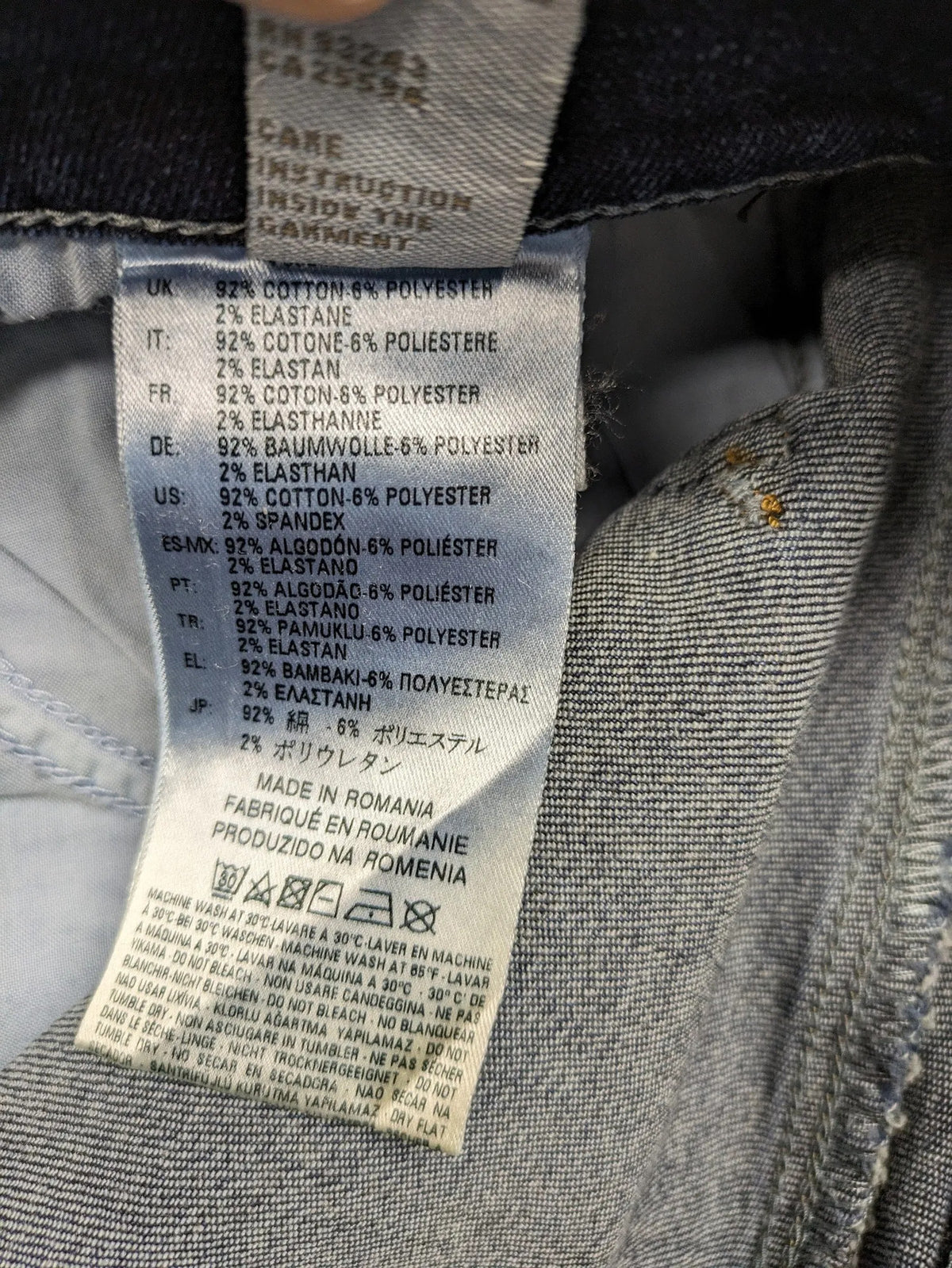 Diesel blue straight jeans with regular waist, dark wash, and stretch material.