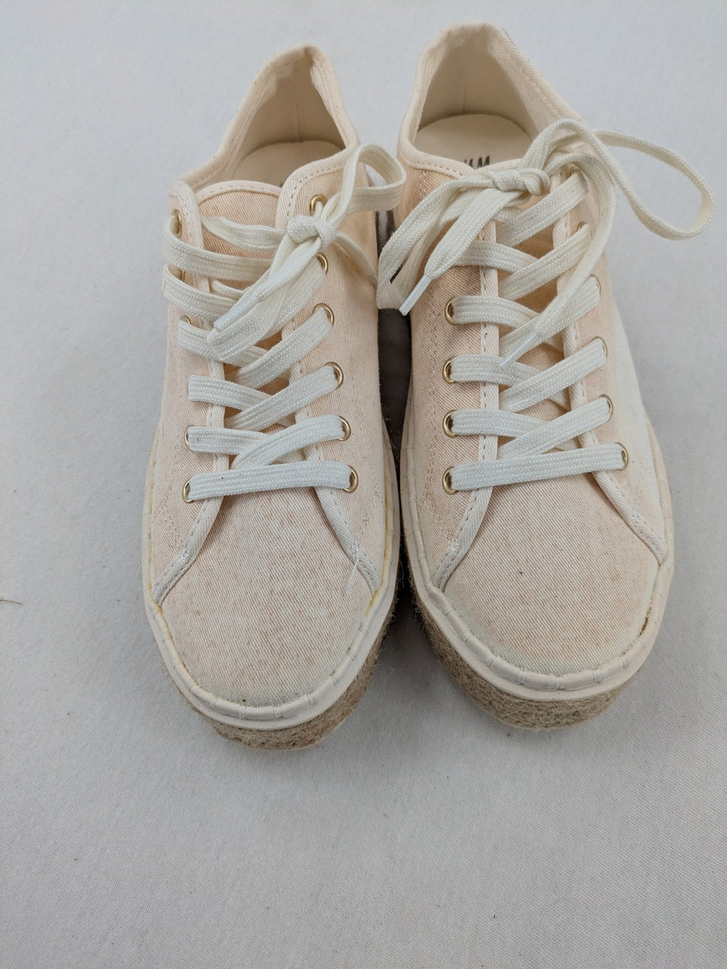 H&M beige espadrille sneakers with jute sole and cream canvas upper.