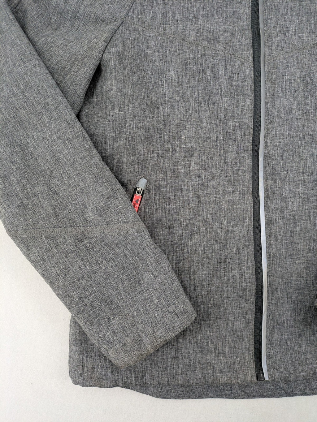 Northville grey and red softshell jacket with hood, fleece lining, and reflective elements.