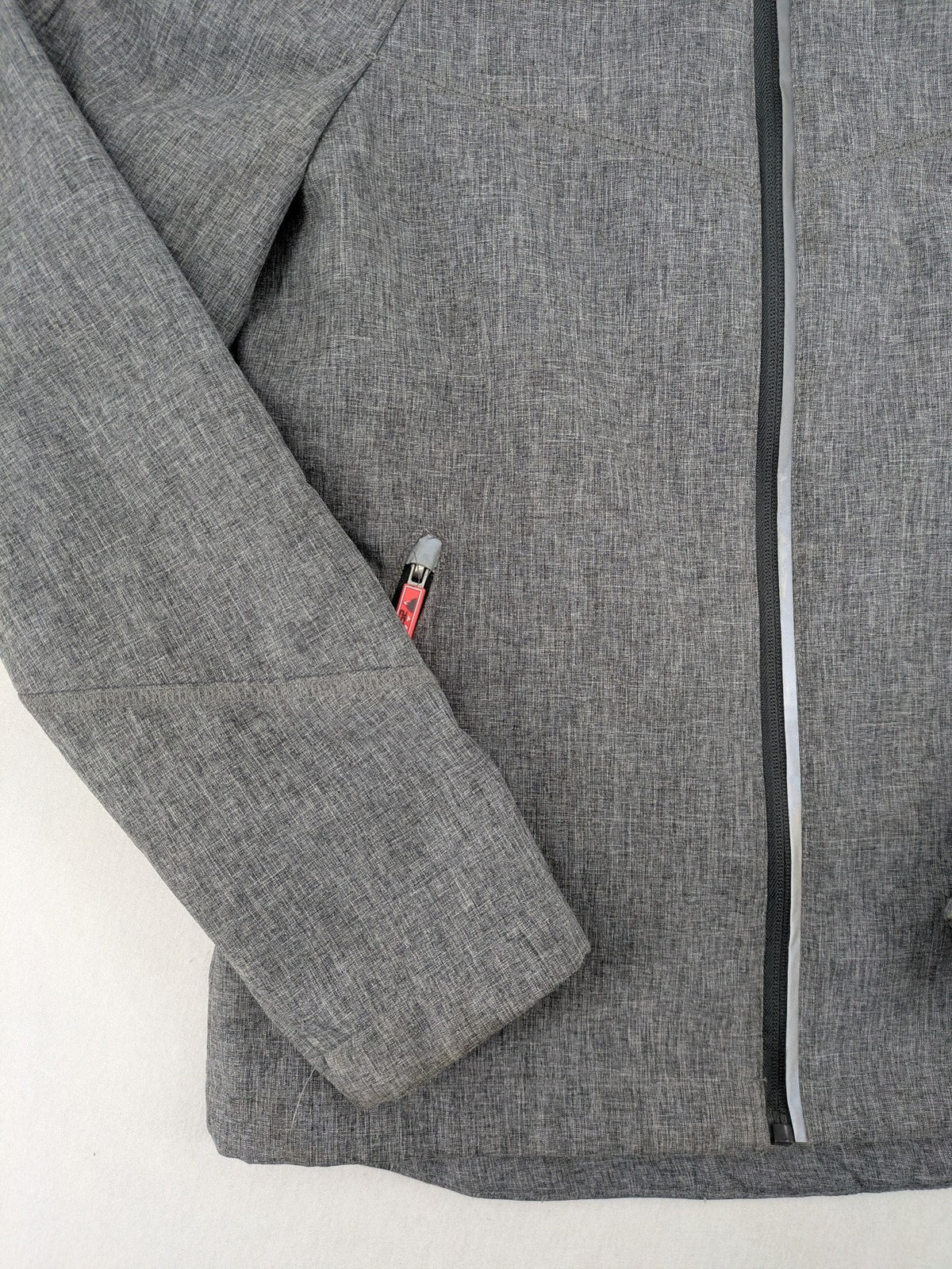Northville grey and red softshell jacket with hood, fleece lining, and reflective elements.