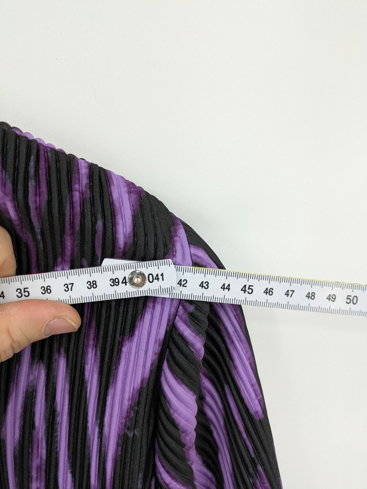 Untold black and purple pleated dress with animal print pattern and long sleeves.