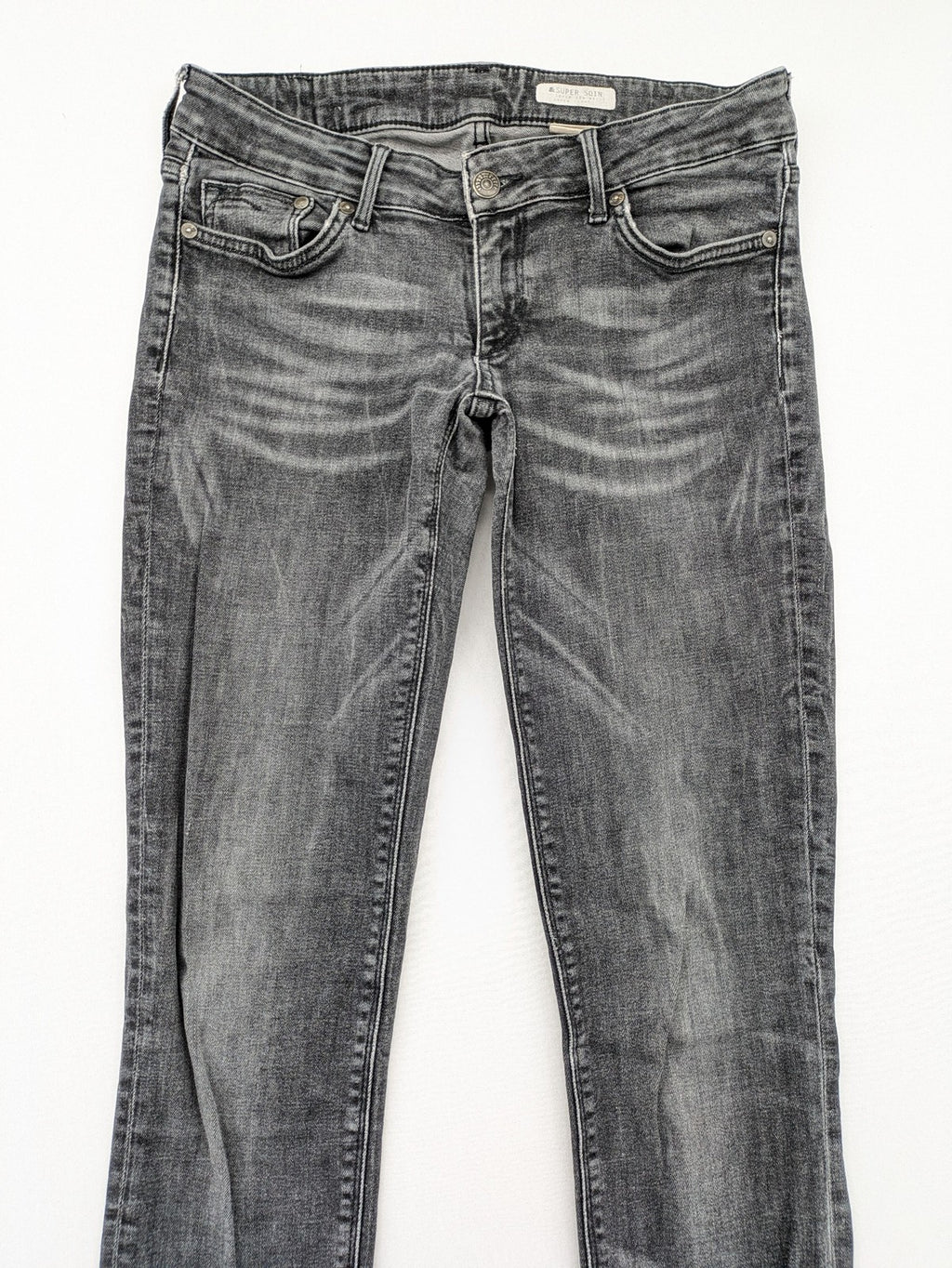 H&M grey skinny jeans with low rise, classic 5-pocket style, and washed denim finish.