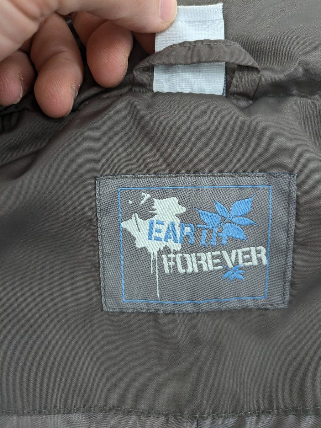 L&A Fashion grey puffer vest with zip closure, stand collar, and side pockets.