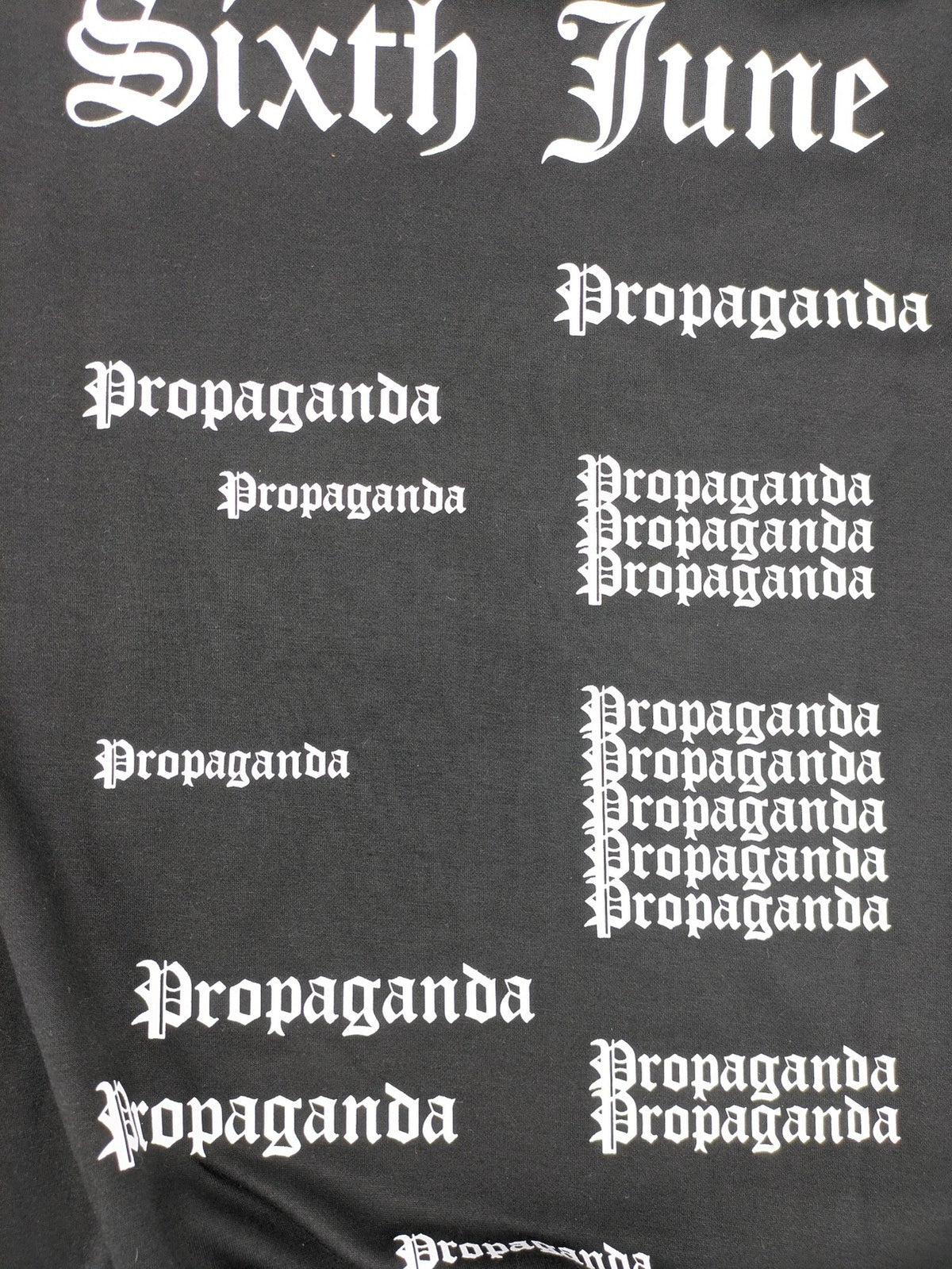Sixth June black sweatshirt with Gothic "Propaganda" graphic print and logo details.