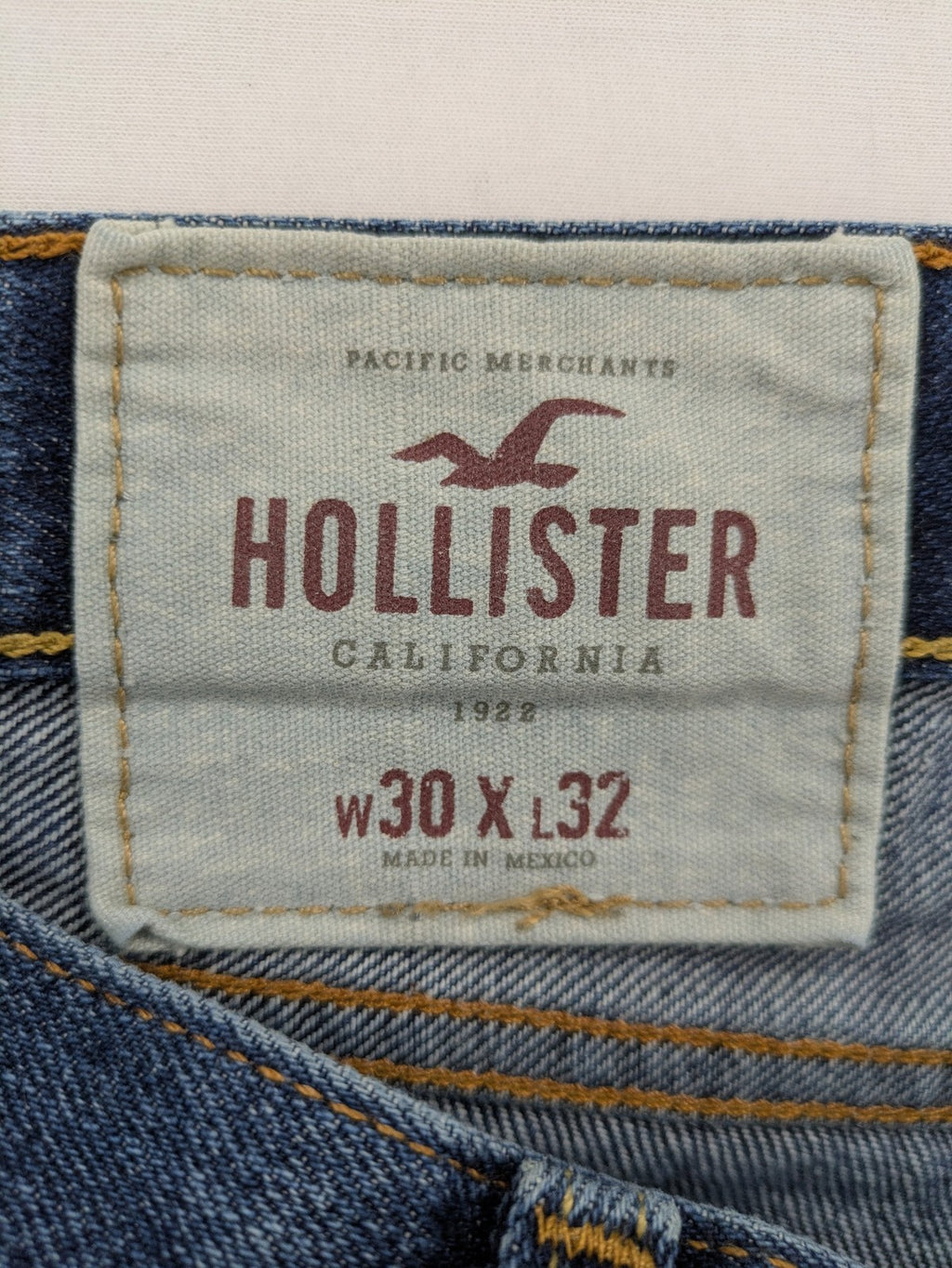 Hollister blue super skinny jeans medium wash button fly with faded details.