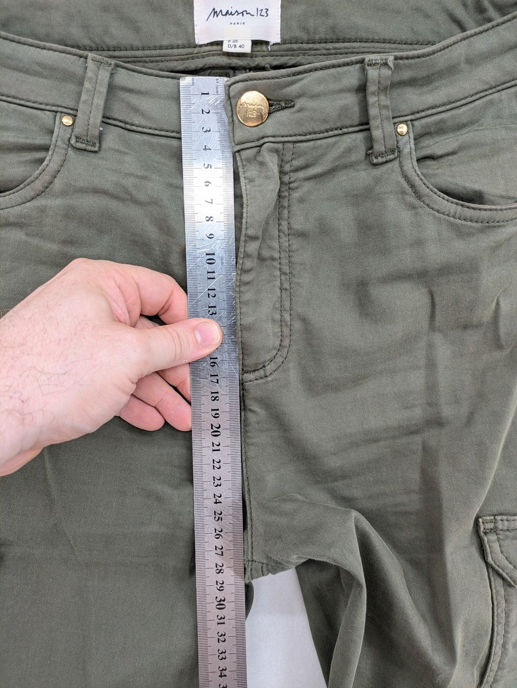 Maison 123 green cargo pants with ankle zippers and gold metal details.