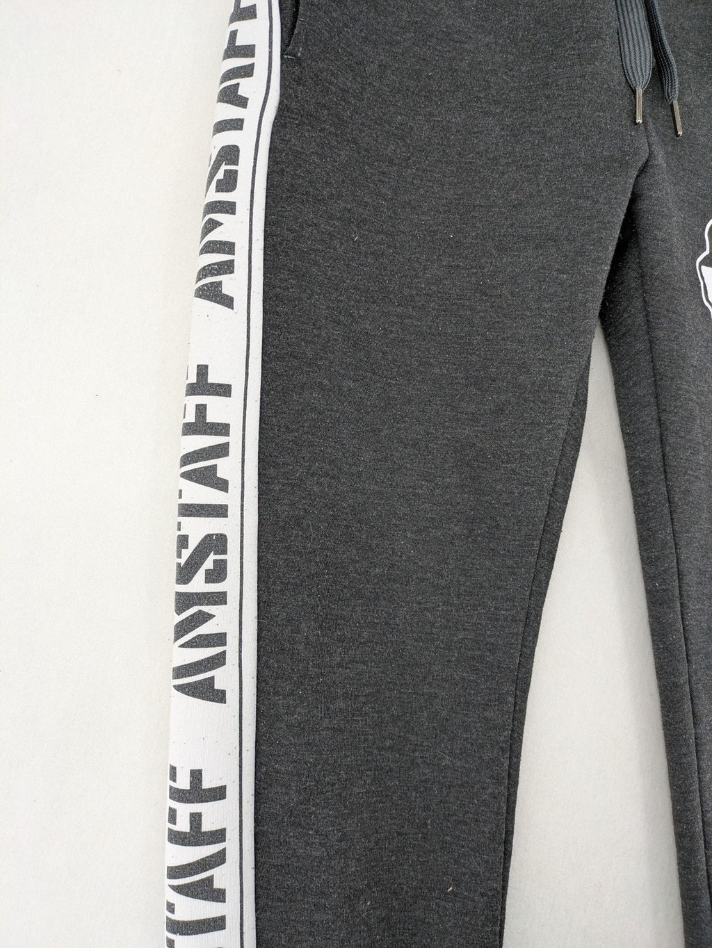 Amstaff grey sweatpants with large dog logo and "Trust & Loyalty" text.