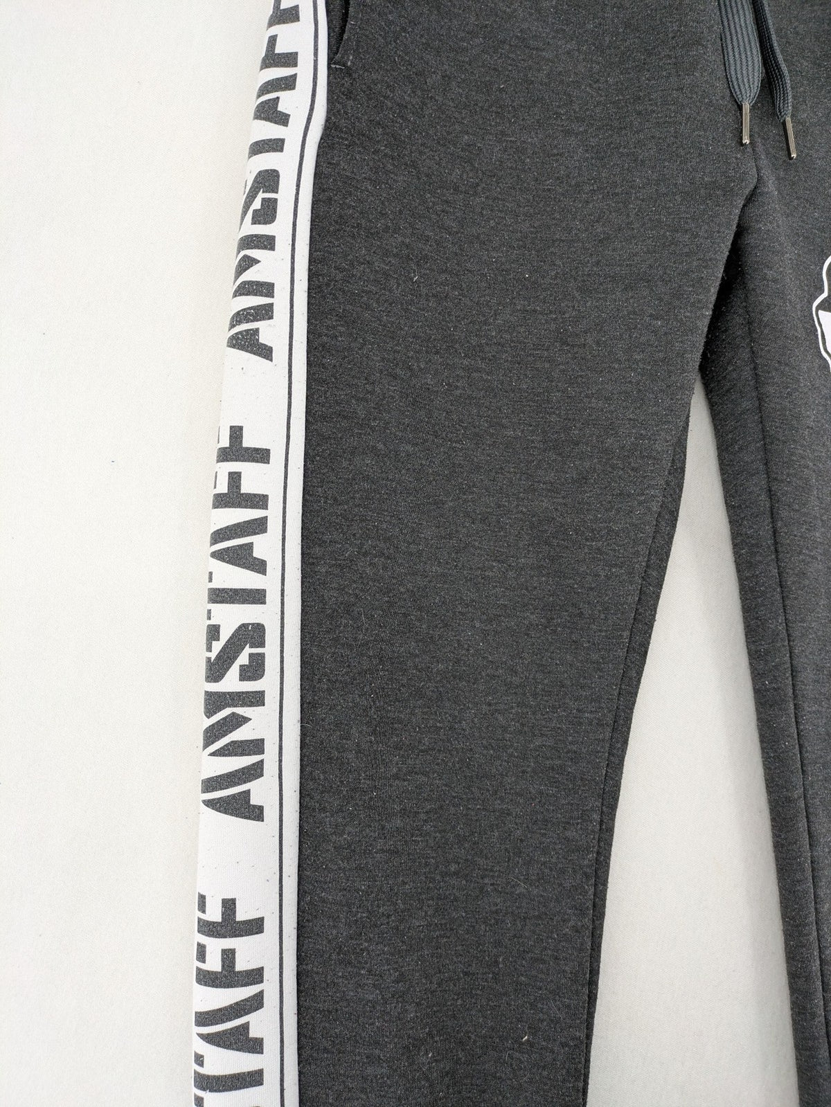 Amstaff grey sweatpants with large dog logo and "Trust & Loyalty" text.