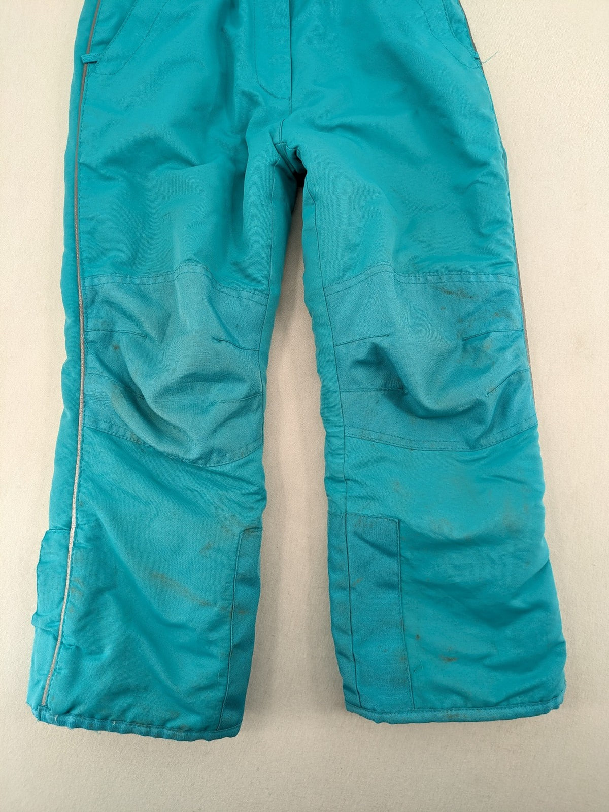 Topolino blue and turquoise snow pants with adjustable straps and fleece-lined bib.