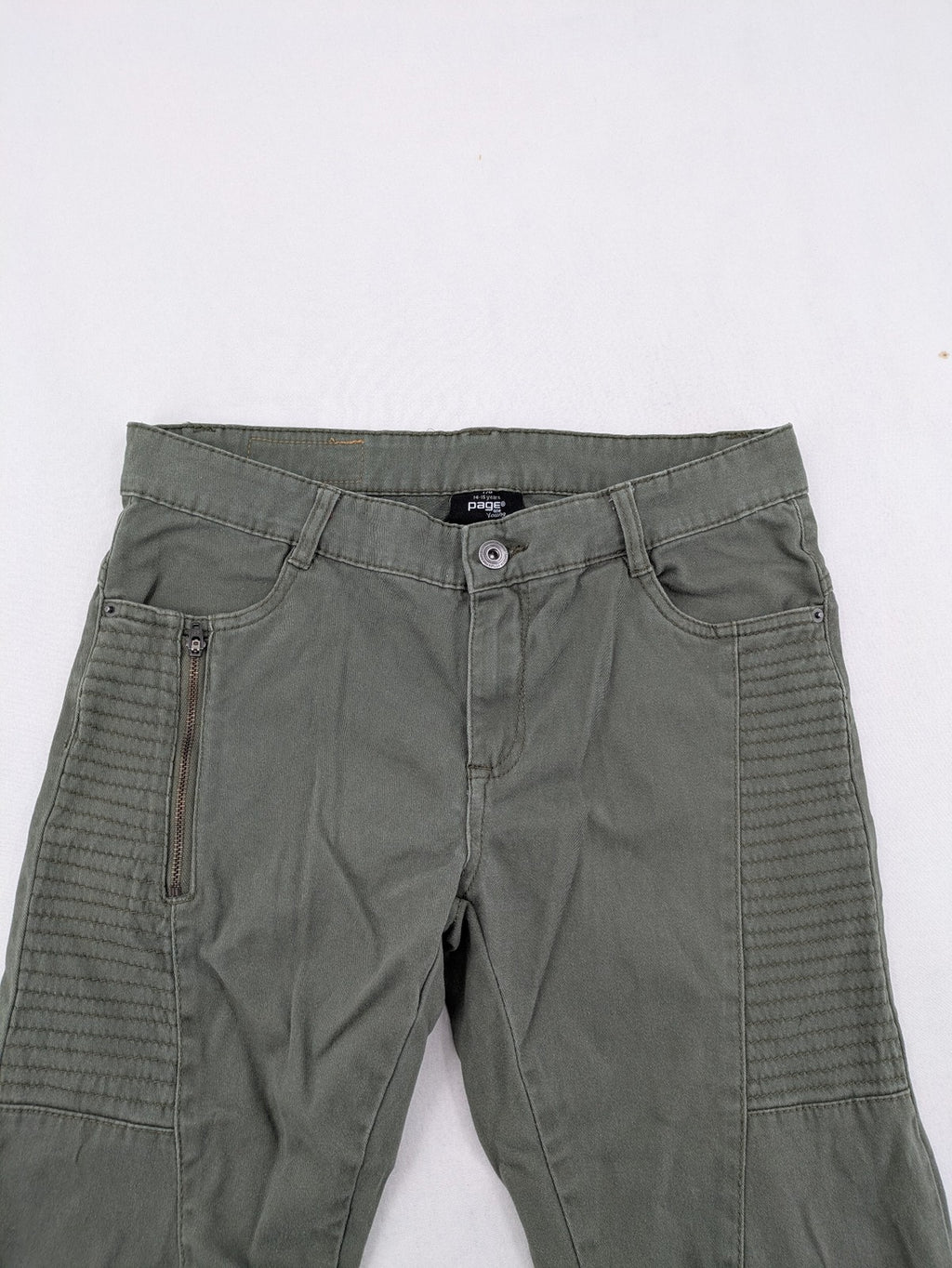 Page One Young khaki motorcycle pants with stitched panels and decorative zipper details.