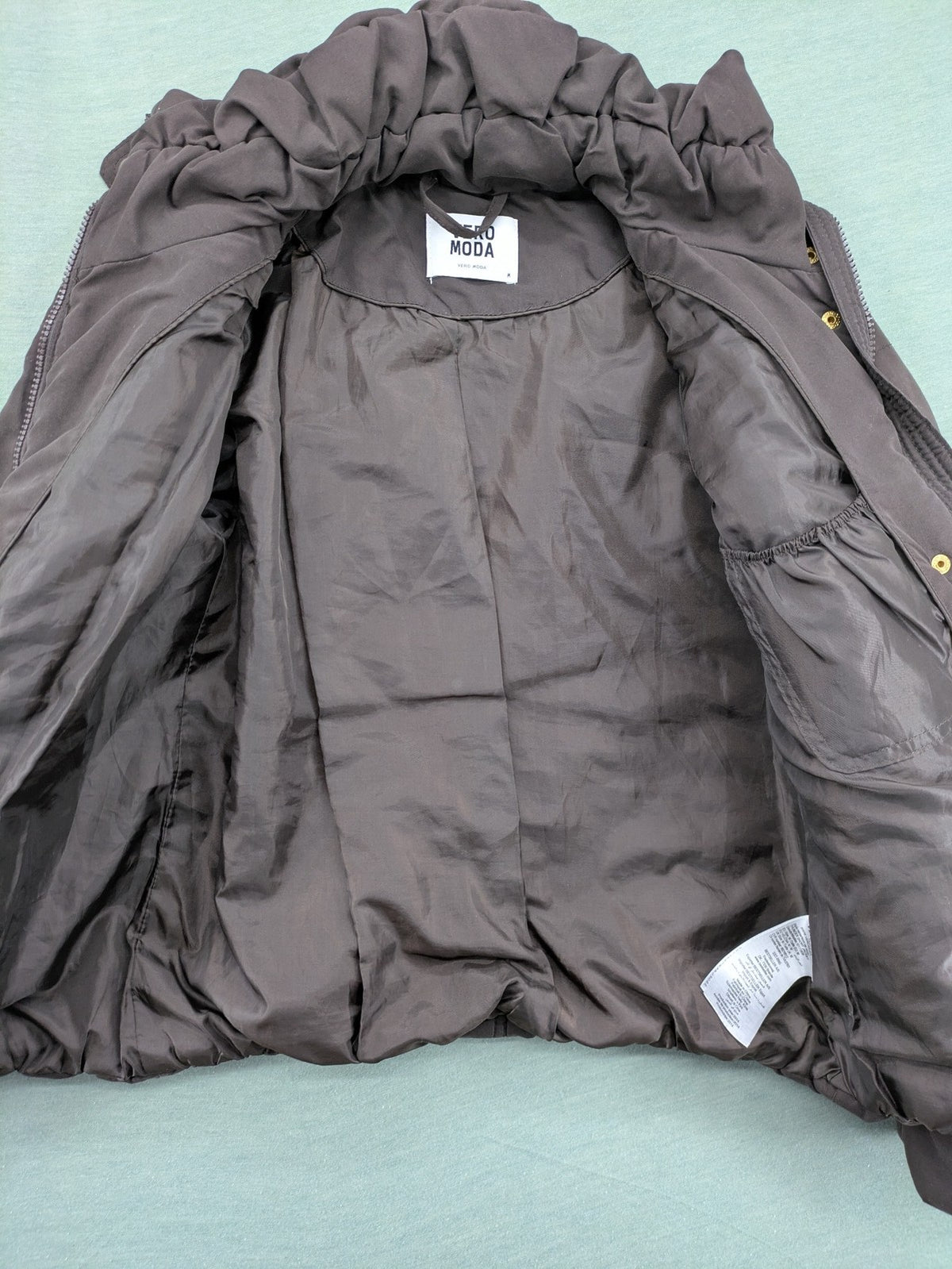 Vero Moda grey quilted jacket with high funnel neck and zippered pockets.