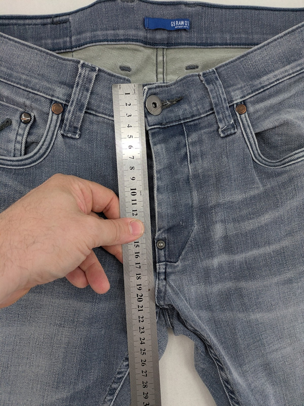 G-Star Raw grey denim straight jeans with classic button fly and subtle branding details.