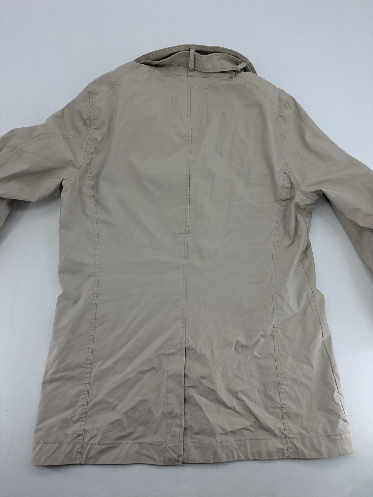 ReSET beige coat with contrasting dark blue lining and classic design details.