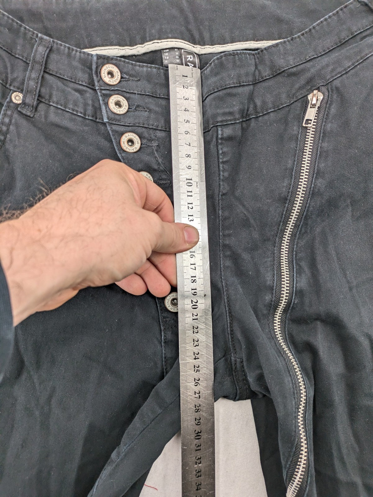 REI grey pants asymmetrical design with diagonal zipper and button placket, cotton blend.