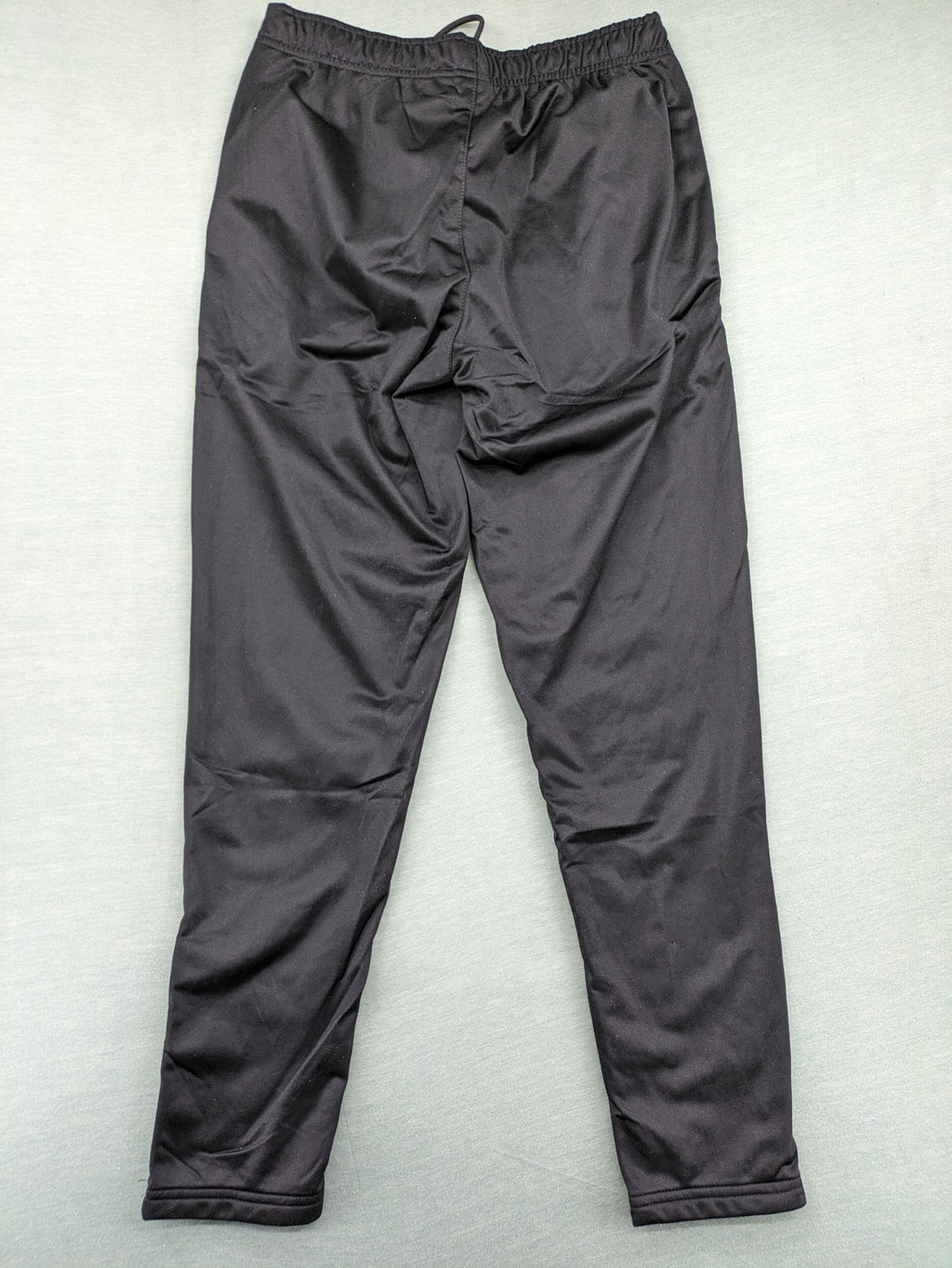 Crivit black weighted training pants with elastic waistband, side pockets, and zippered cuffs.