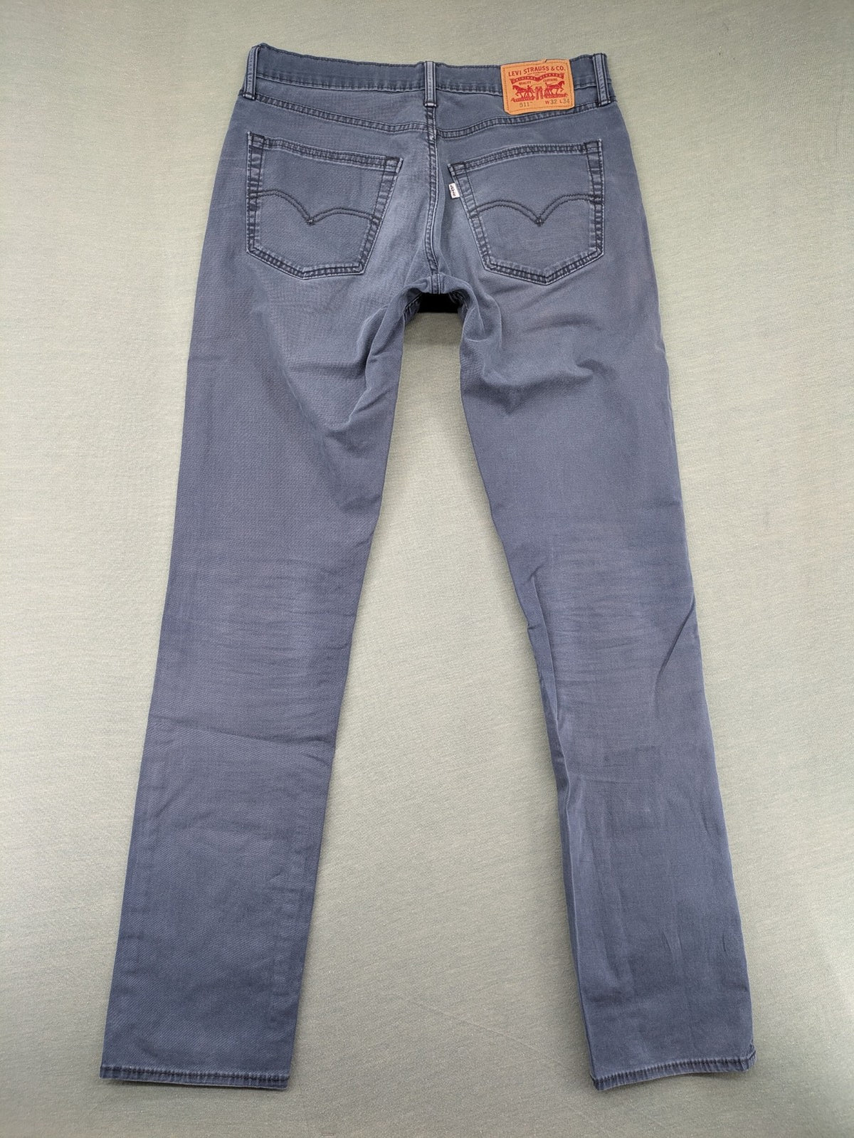 Levi's blue slim fit jeans with faded wash and classic 5-pocket design.