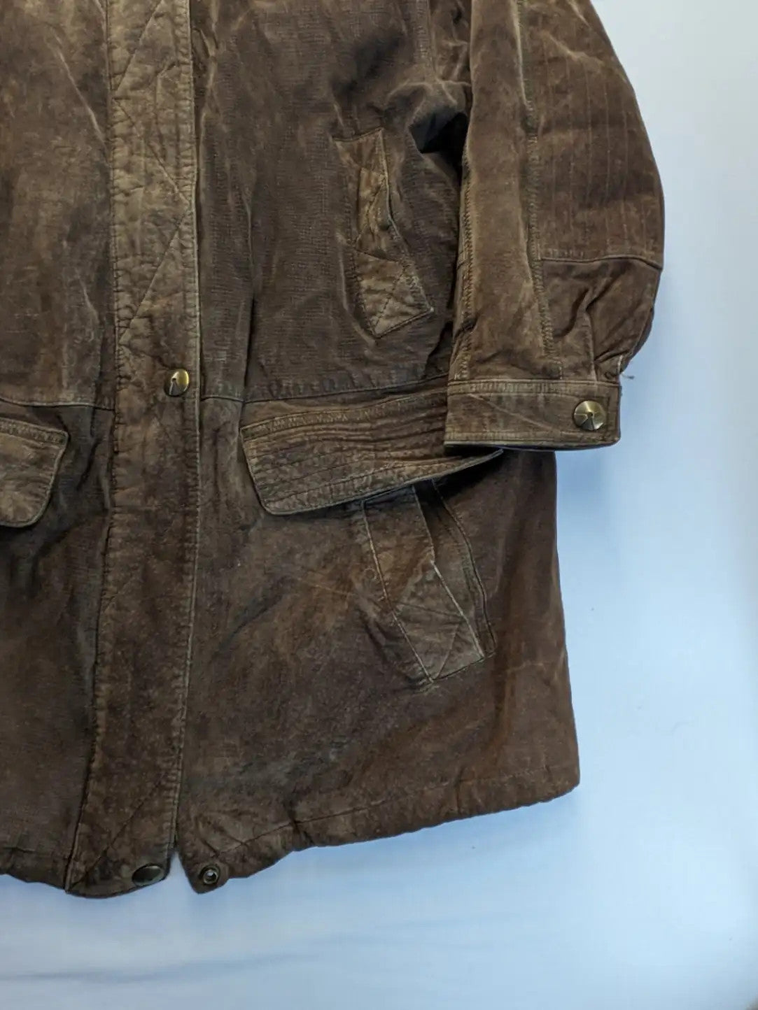 Vintage brown leather jacket with graphic lining, zip closure, and button placket.